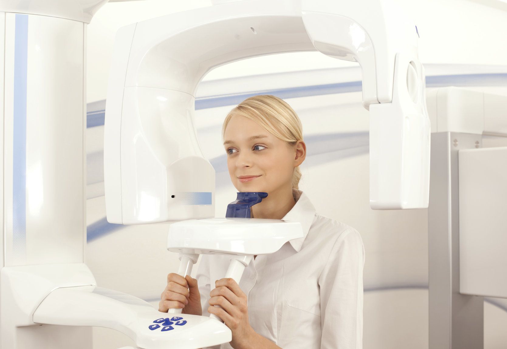 A photo of a woman positioning her head for a CT scan.